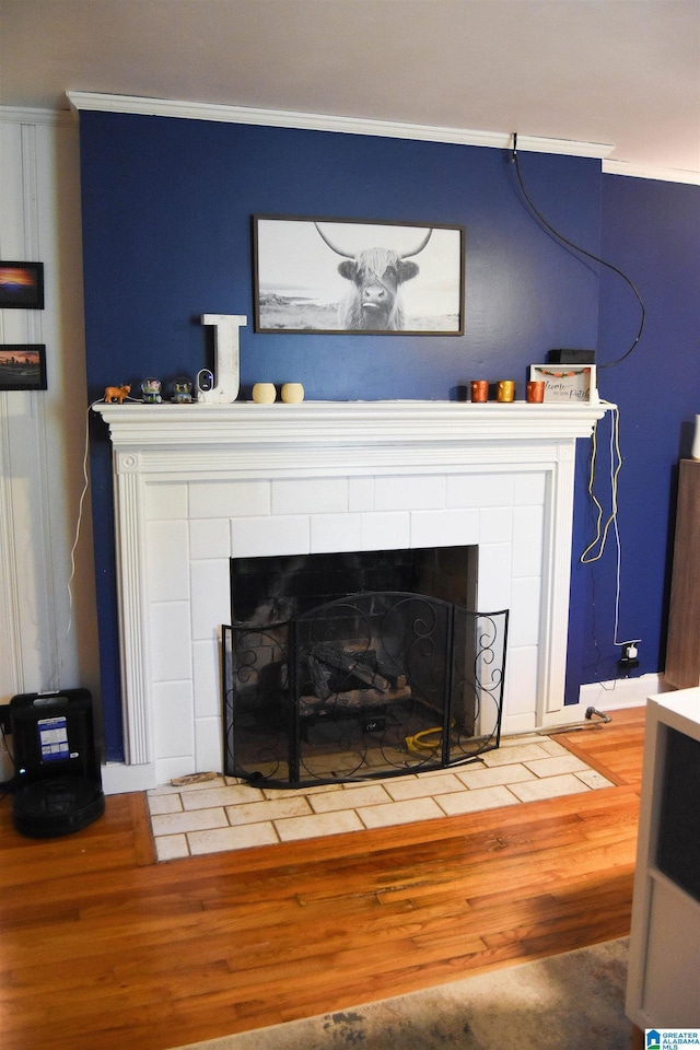 details with crown molding and a tiled fireplace