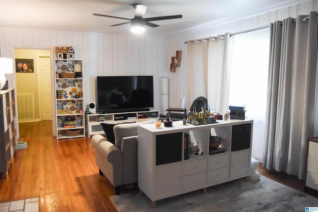 living room featuring ceiling fan and hardwood / wood-style flooring