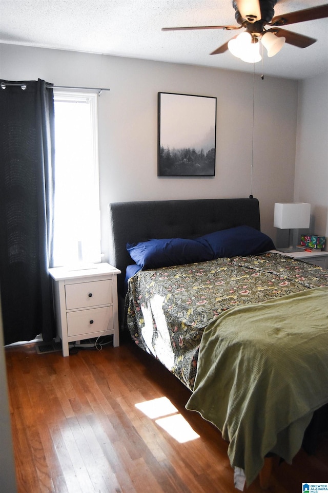 bedroom featuring ceiling fan and hardwood / wood-style flooring