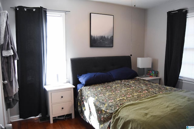 bedroom with dark hardwood / wood-style flooring