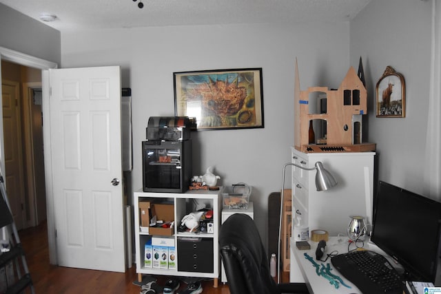 office space featuring a textured ceiling and dark hardwood / wood-style flooring