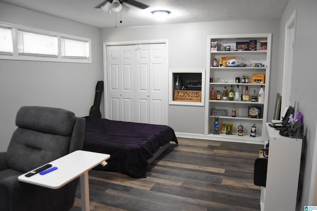 bedroom featuring ceiling fan, a closet, and dark hardwood / wood-style floors