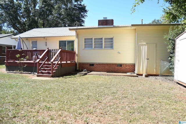 rear view of house featuring a lawn, central AC unit, and a wooden deck