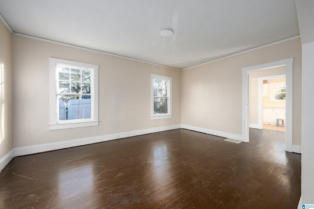 spare room with dark hardwood / wood-style flooring and ornamental molding