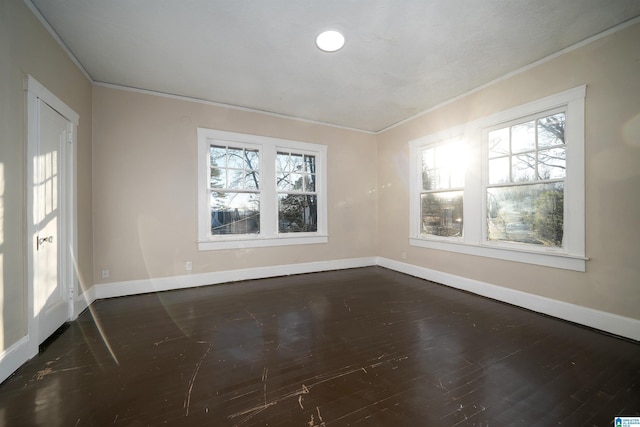 unfurnished room with ornamental molding and dark hardwood / wood-style floors