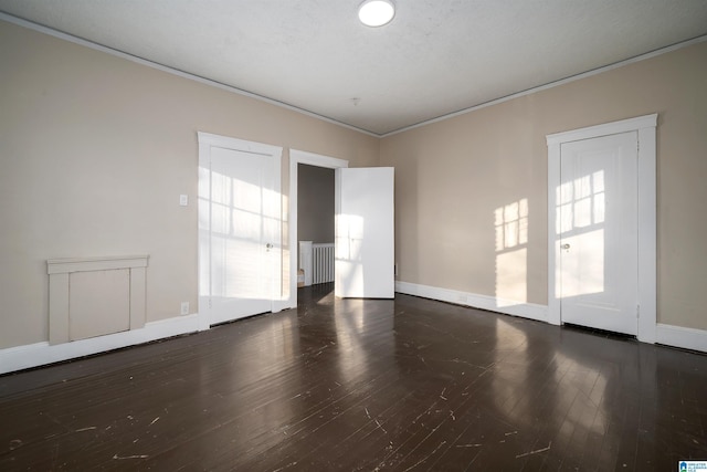 unfurnished room with dark wood-type flooring and ornamental molding