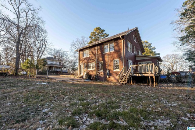 back of property featuring a wooden deck