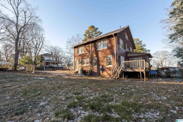 back of property featuring a wooden deck