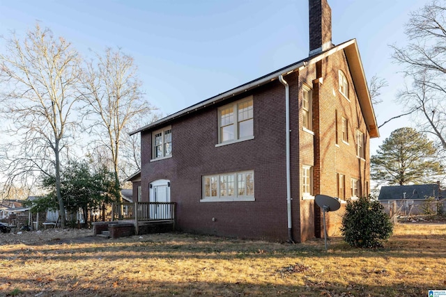 rear view of property featuring a yard