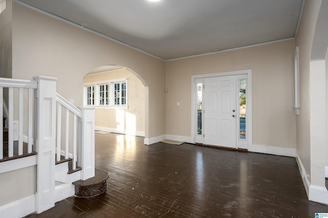 entryway with dark wood-type flooring and ornamental molding