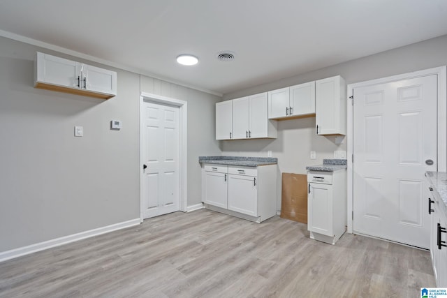 kitchen featuring white cabinetry and light hardwood / wood-style flooring