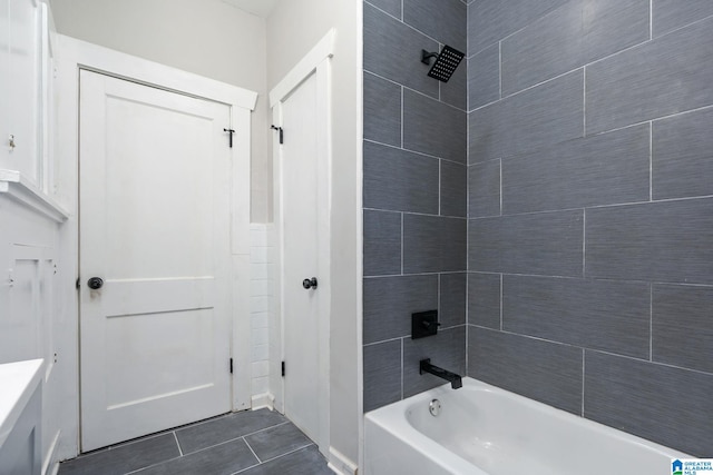 bathroom featuring tiled shower / bath combo and tile patterned floors