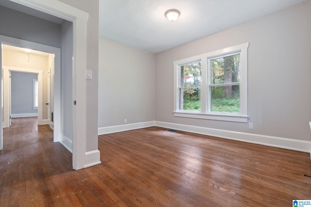 spare room featuring dark wood-type flooring