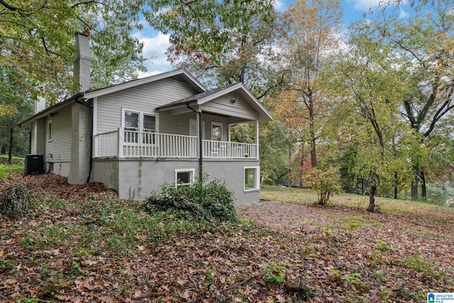 view of front of house with cooling unit and a porch