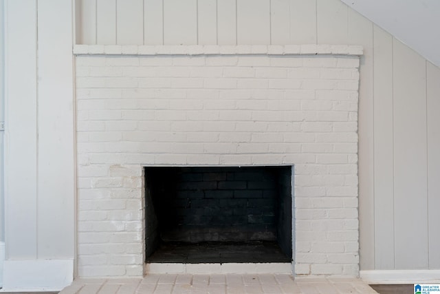 room details featuring a brick fireplace