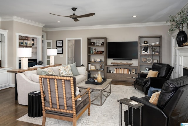 living room with ceiling fan, light hardwood / wood-style flooring, and ornamental molding