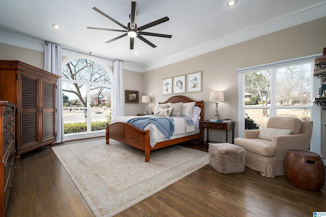 bedroom featuring ceiling fan, crown molding, and dark hardwood / wood-style floors