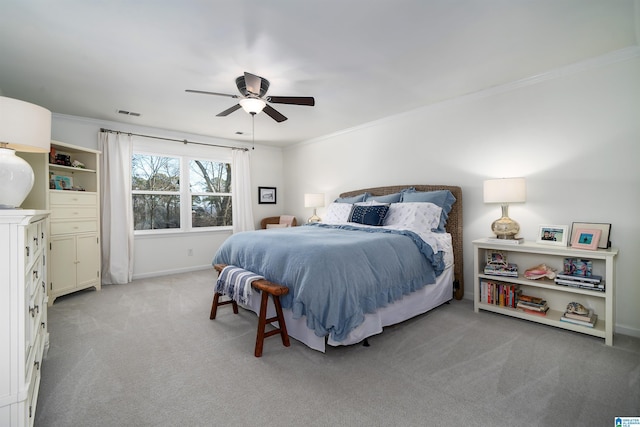 bedroom featuring ceiling fan, ornamental molding, and light carpet