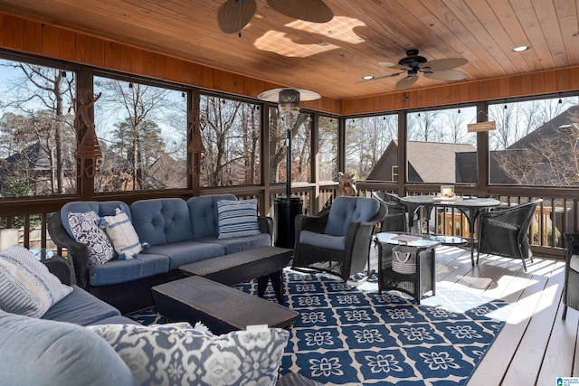 sunroom / solarium with ceiling fan and wooden ceiling