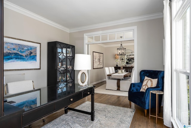 office area with dark wood-type flooring, ornamental molding, and an inviting chandelier