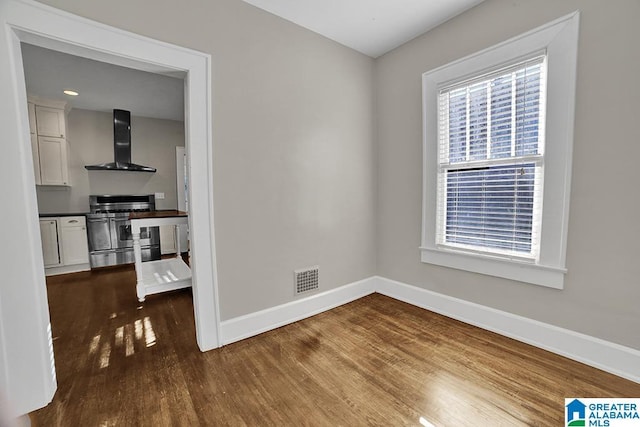 unfurnished room with wood-type flooring