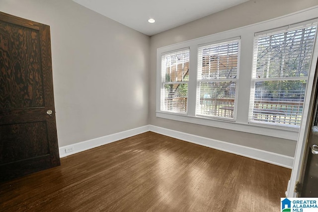 empty room with dark wood-type flooring