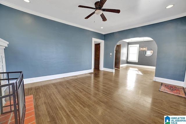 unfurnished room featuring ceiling fan, dark hardwood / wood-style flooring, and ornamental molding