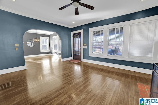 foyer entrance featuring crown molding, ceiling fan with notable chandelier, and hardwood / wood-style floors