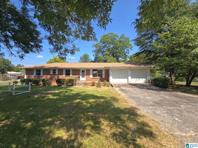 ranch-style house featuring a front lawn and a garage