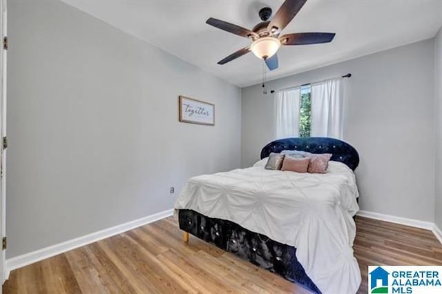 bedroom with wood-type flooring and ceiling fan