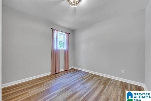 empty room with light hardwood / wood-style flooring