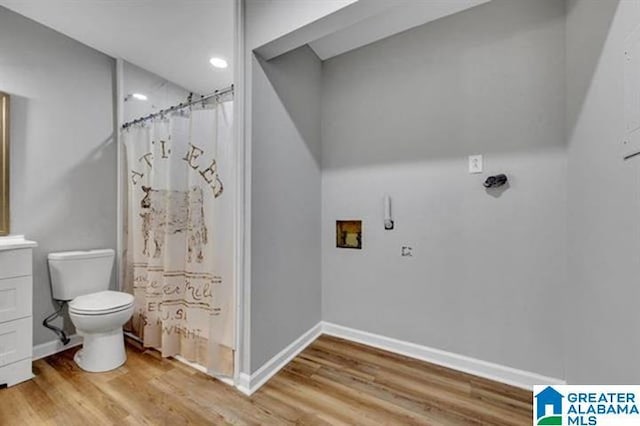 bathroom featuring a shower with curtain, vanity, hardwood / wood-style floors, and toilet