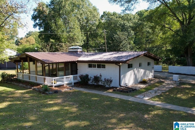 view of front of house with covered porch and a front yard