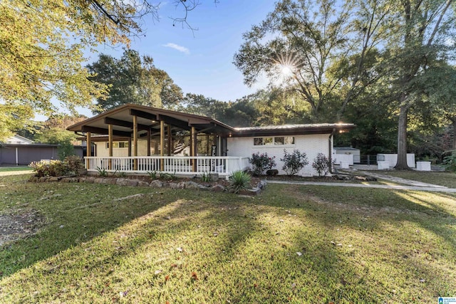 view of front of property featuring covered porch and a front yard