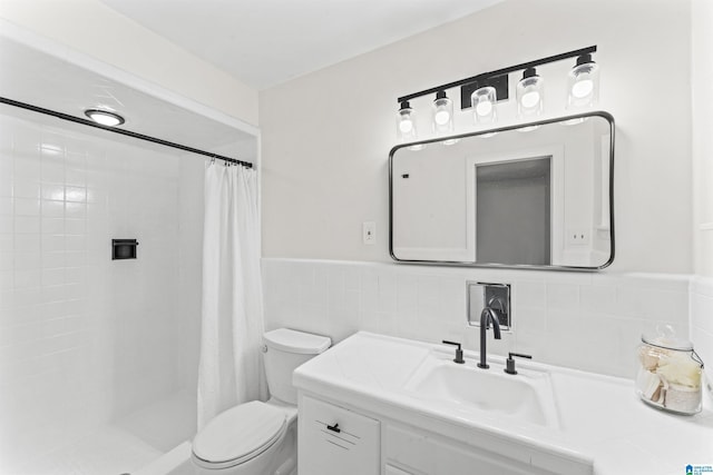 bathroom with a shower with curtain, toilet, vanity, and tile walls