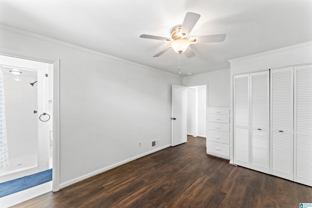 unfurnished bedroom with crown molding, a closet, dark hardwood / wood-style floors, and ceiling fan