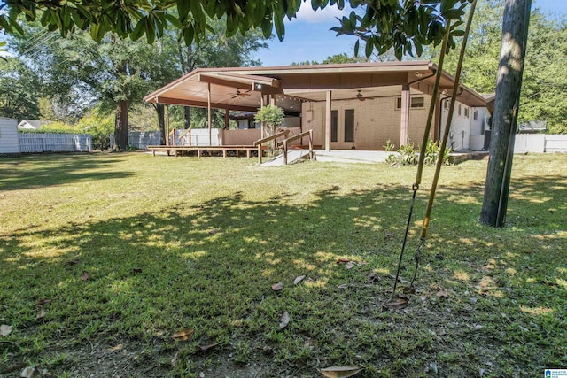 back of house featuring ceiling fan, a patio area, and a yard