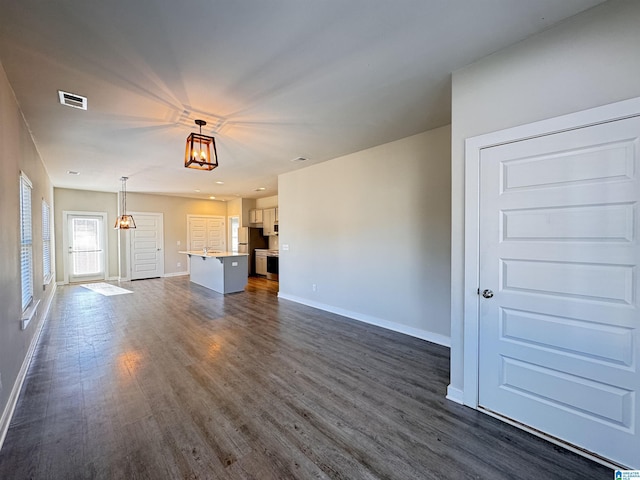 unfurnished living room featuring dark hardwood / wood-style flooring