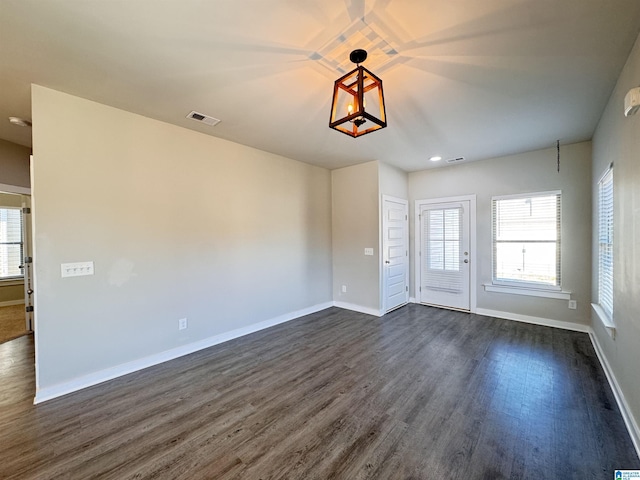 empty room with dark wood-type flooring