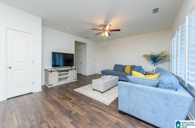 living room with dark wood-type flooring and ceiling fan