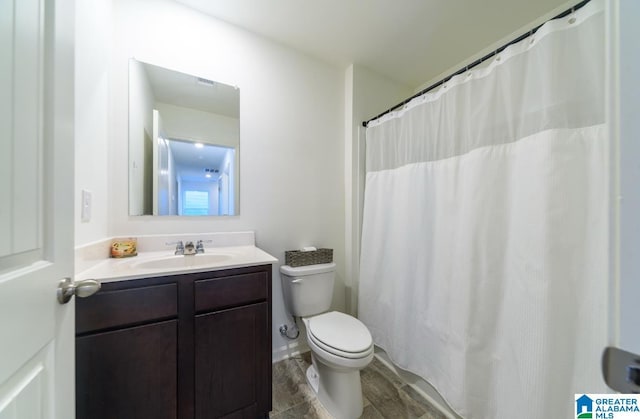 bathroom featuring hardwood / wood-style flooring, vanity, and toilet