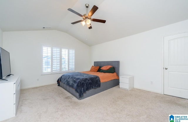 carpeted bedroom with vaulted ceiling and ceiling fan