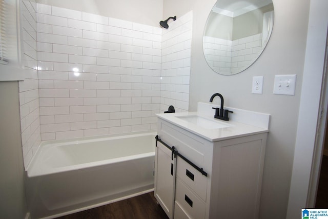 bathroom featuring vanity, tiled shower / bath, and wood-type flooring