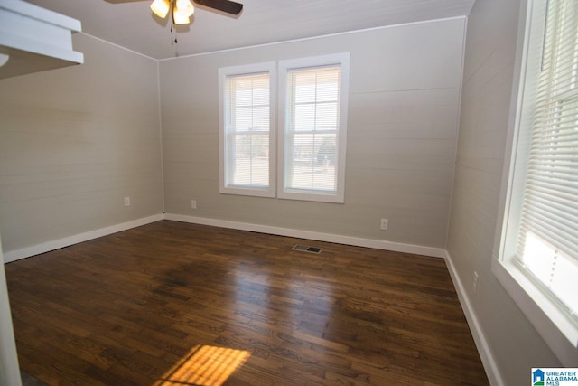 spare room featuring dark hardwood / wood-style floors and ceiling fan