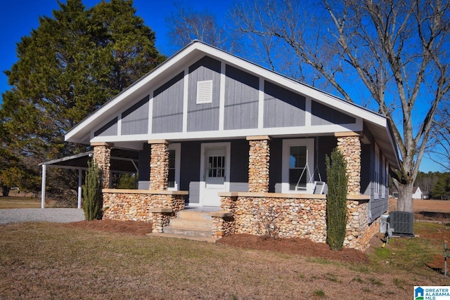 view of front of home featuring a front lawn, a porch, and central AC unit