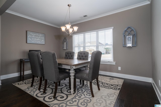 dining room with hardwood / wood-style floors, ornamental molding, and a notable chandelier