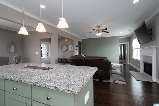 kitchen featuring hanging light fixtures, dark hardwood / wood-style floors, green cabinets, and a kitchen island