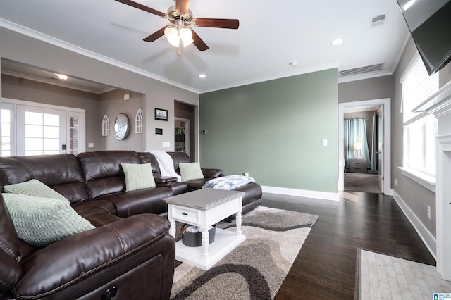 living room featuring a healthy amount of sunlight, crown molding, and wood-type flooring