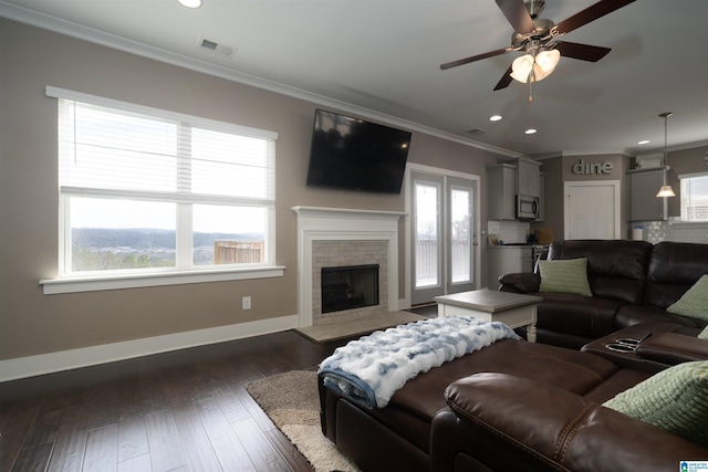 living room with ceiling fan, crown molding, and dark hardwood / wood-style floors