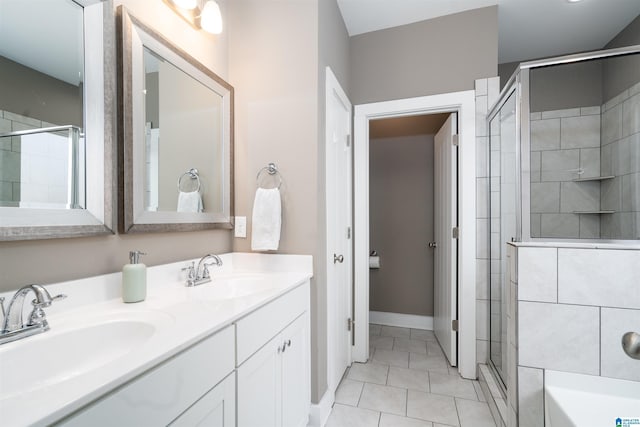 bathroom featuring a shower with door, vanity, and tile patterned flooring